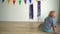 Funny active kid playing with water ball on floor at home. Gimbal motion shot