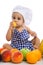 Funny adorable baby with green apples and different fruits
