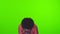 Funny African American girl sneezes closing face on green