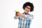 Funny afro american man aiming from banana