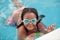 Funny afroamerican girl with goggles in the pool