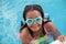 Funny afroamerican girl with goggles in the pool