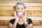 Funny and alternative old people caucasian beautiful woman with pink bubble chewing gum - portrait of youth active senior lady