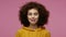 Funny amusing girl afro hairstyle in hoodie looking awkward with crossed eyes and puffed cheeks, fooling around