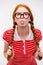 Funny amusing girl in round glasses showing tongue