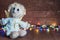 Funny angel and bright lights garlands on wooden boards