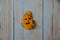 A funny angry smiley emoticon face drawn on a yellow golden leaf