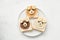 Funny animal face toasts with nut butter, banana and blueberries on white plate