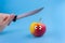 funny apple with a knife