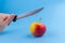 funny apple with a knife