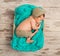 Funny asleep newborn baby in wicker cot