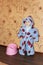 Funny baby in bathrobe near plastic potty