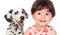 Funny baby with a beautiful dalmatian dog isolated on a white ba