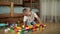 Funny baby boy with educational toy blocks.