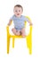Funny baby boy toddler sitting on little chair isolated on white