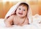 Funny baby child under a hooded towel after bath