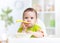 Funny baby eating food on kitchen