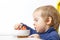 Funny Baby eats vegetable soup spoon