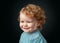 Funny baby face close up. Smiling infant, cute smile. Kids head portrait. Isolated on black studio.