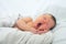 Funny baby face,newborn with jaundice on white blanket, infant healthcare