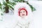 Funny baby girl in snow under Christmas tree