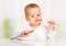 Funny baby with a knife and fork eating food