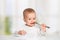 Funny baby with a knife and fork eating food