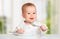 Funny baby with a knife and fork eating food