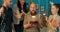 Funny bald man with beard celebrates birthday is surprised party organized by friends, everyone has