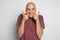 Funny bald man shows his thumbs up isolated