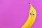 Funny banana fruit with googly eyes on purple background with blank copy space