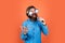 funny bearded brutal man with moustache wear party glasses and sing song in microphone, event manager