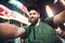 Funny bearded man backpacker smiling and taking selfie photo on Times Square in New York while travel across USA