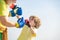 Funny bearded man - grandfather with child boy standing in boxing pose. Fighter. Handsome elderly man practicing boxing