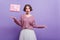 Funny birthday girl in sweater expressing surprised emotions on purple background. Emotional short-haired lady in white