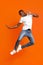 Funny black guy bouncing over orange background