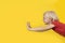 Funny blond boy in red shirt is flying. Portrait of child on bright yellow background. Copy space