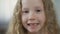 Funny blond child showing teeth into camera, children\'s orthodontics, health