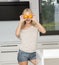 Funny blond girl doing orange glasses