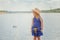 Funny blonde girl posing on background of lake