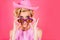 Funny blonde woman with pink cowboy hat. Young american cowgirl woman portrait. Pretty woman, fashion and beauty.