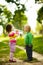 Funny boy and girl drinking mineral water in park