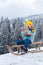 Funny boy having fun with a sleigh in winter forest woods. Cute children sledging in a snow mountain on winter