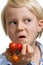 Funny boy holding bunch of tomatoes