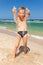 Funny boy playing with sand on the beach