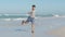 Funny boy posing dancing on beach having fun and positive emotion slowmo. Laughing male kid rejoicing demonstrate dance