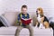 Funny boy reading a book with a beagle