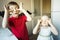 Funny brother and sister close their eyes with candy like glasses