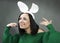 Funny Brunette in a bright sweater with rabbit ear