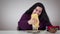 Funny brunette Caucasian woman pouring ketchup and mayonnaise on bread and smiling. Plump cheerful girl pouring dressing